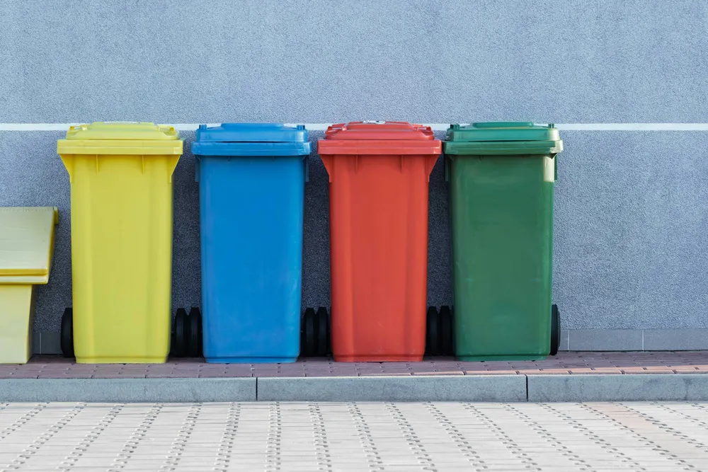 Four colour-coded bins for non-hazardous recyclable materials